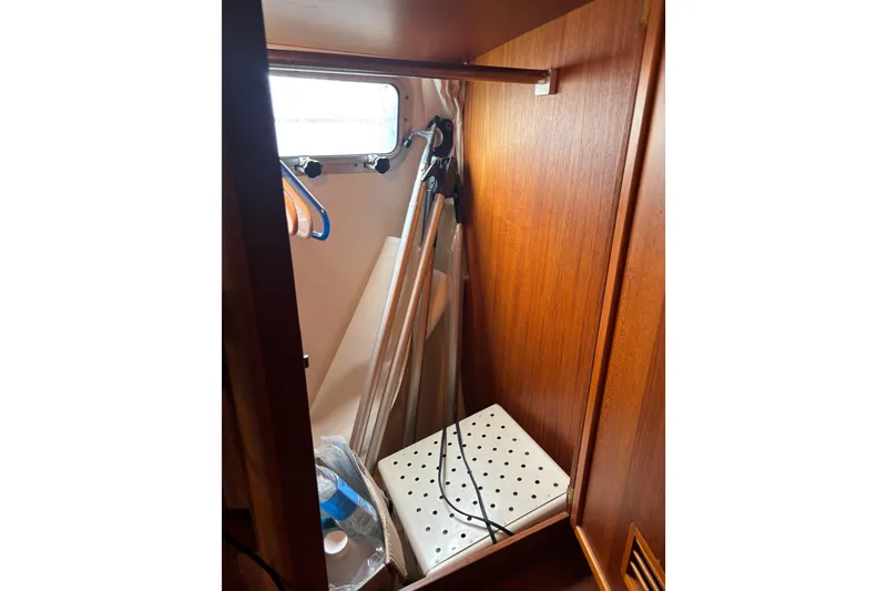 Slide: The Image of Interior storage space of 2001 Nauticat Staysail Ketch with wooden finish and window. - 28