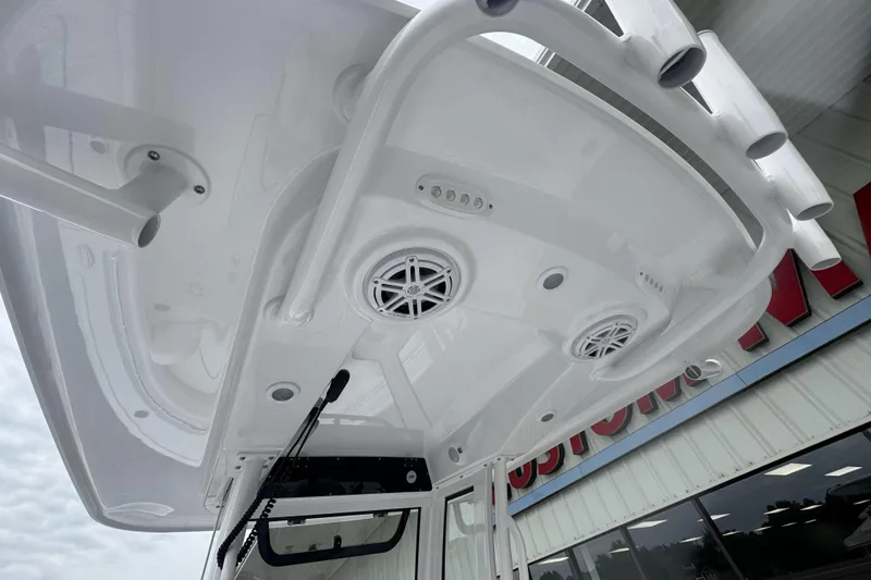 Slide: The Image of 2026 Sportsman Open 212 Center Console boat with speakers and rod holders. - 11