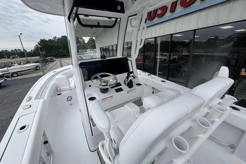Slide: The Image of 2026 Sportsman Open 212 Center Console boat interior with steering wheel and seating. - 12
