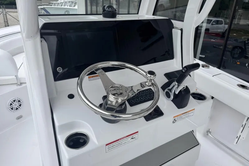 Slide: The Image of 2026 Sportsman Open 212 Center Console helm with steering wheel and controls. - 15
