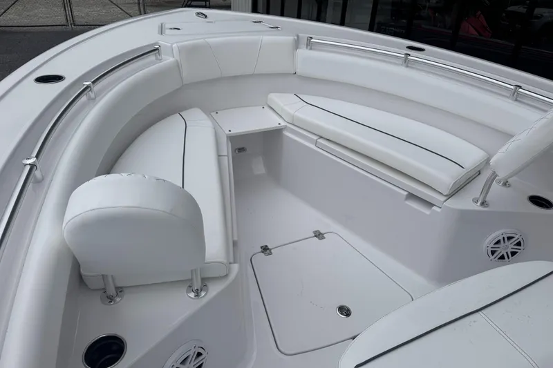Slide: The Image of 2026 Sportsman Open 212 Center Console boat interior with white cushioned seating. - 16