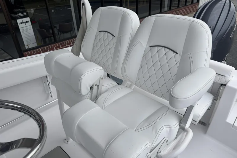 Slide: The Image of Luxurious white seating on 2026 Sportsman Open 212 Center Console boat, featuring diamond stitching. - 17