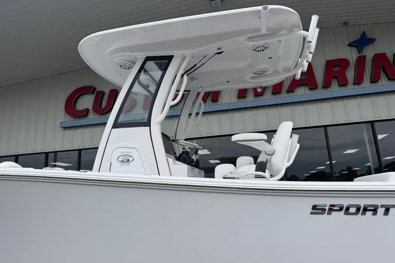 Slide: The Image of 2026 Sportsman Open 212 Center Console boat displayed at Custom Marine dealership. - 2