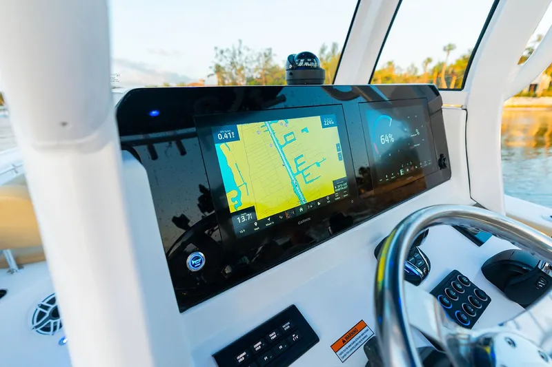 Slide: The Image of Manufacturer Provided Image: 2025 Sportsman Open 212 Center Console dashboard with navigation screens and steering wheel. - 27