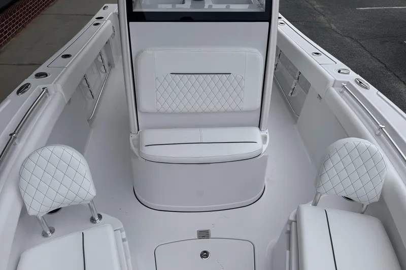 Slide: The Image of 2026 Sportsman Open 212 Center Console boat interior with white seating and diamond stitching. - 7