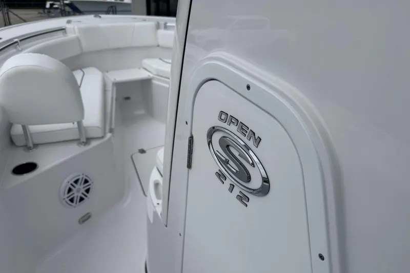 Slide: The Image of 2026 Sportsman Open 212 Center Console boat interior with sleek white seating. - 9