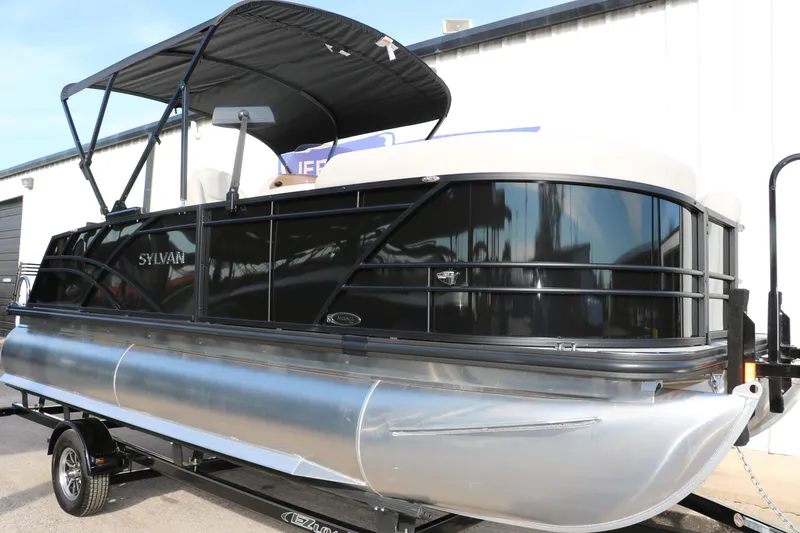 Slide: The Image of 2026 Sylvan Mirage 820 CLZ DH Premium Pontoon with sleek black design on trailer. - 1