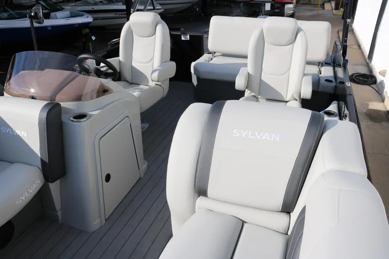 Slide: The Image of 2026 Sylvan Mirage 820 CLZ DH Premium Pontoon interior with luxurious seating and helm. - 11