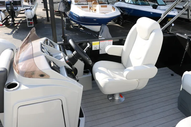 Slide: The Image of 2026 Sylvan Mirage 820 CLZ DH Premium Pontoon interior with captain's chair and dashboard. - 23