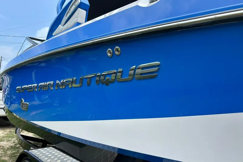Slide: The Image of 2013 Nautique Super Air Nautique G23 boat, blue exterior, close-up view. - 18