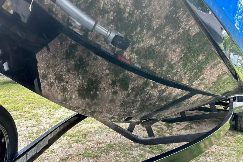 Slide: The Image of 2013 Nautique Super Air Nautique G23 boat hull on trailer, reflecting surroundings. - 19