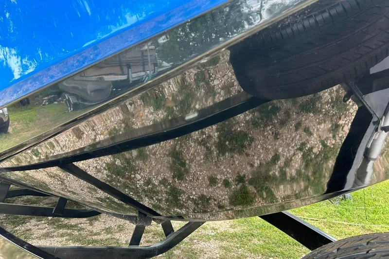 Slide: The Image of 2013 Nautique Super Air Nautique G23 boat hull on trailer, reflecting surroundings. - 20