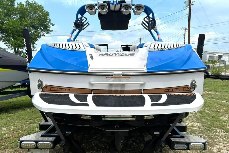 Slide: The Image of 2013 Nautique Super Air Nautique G23 boat, blue and white, rear view with speakers. - 21