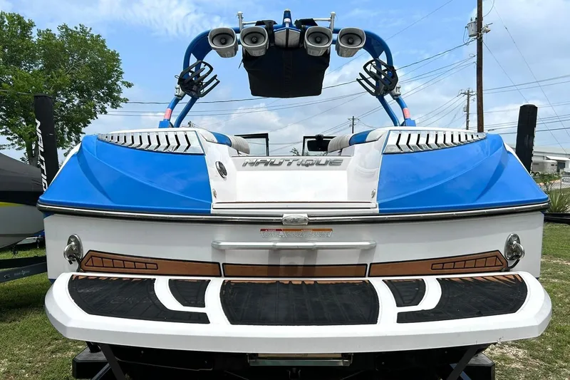 Slide: The Image of 2013 Nautique Super Air Nautique G23 boat, rear view, blue and white design. - 22