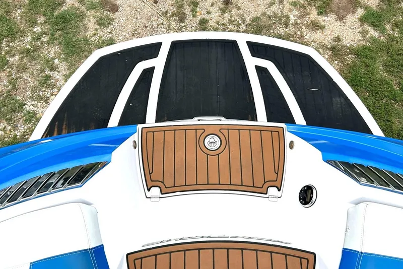 Slide: The Image of 2013 Nautique Super Air Nautique G23 boat deck, featuring blue and white accents. - 23