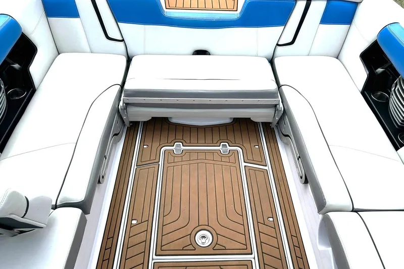 Slide: The Image of 2013 Nautique Super Air Nautique G23 interior with white seating and teak flooring. - 30