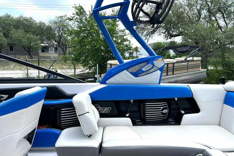 Slide: The Image of 2013 Nautique Super Air Nautique G23 interior with blue and white seating, showcasing sleek design. - 31