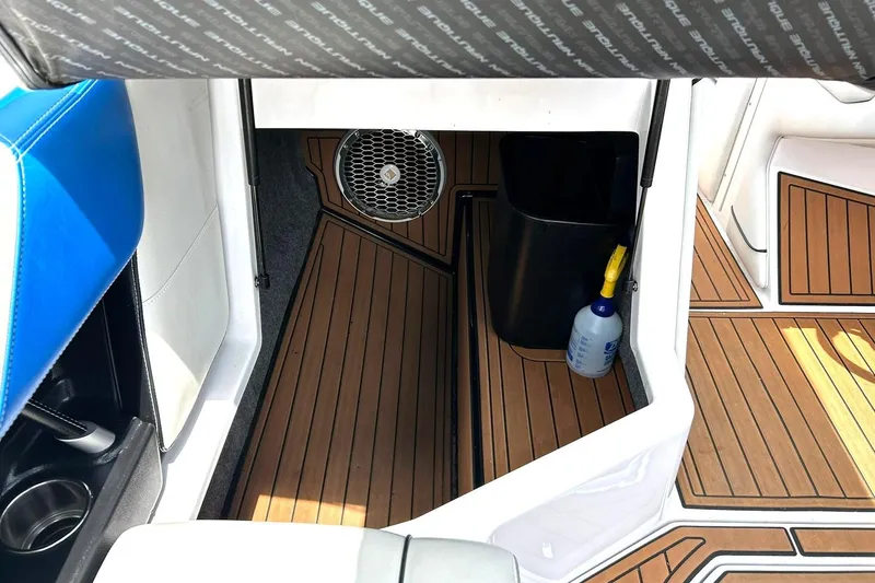 Slide: The Image of 2013 Nautique Super Air Nautique G23 interior with teak flooring and storage compartment. - 37