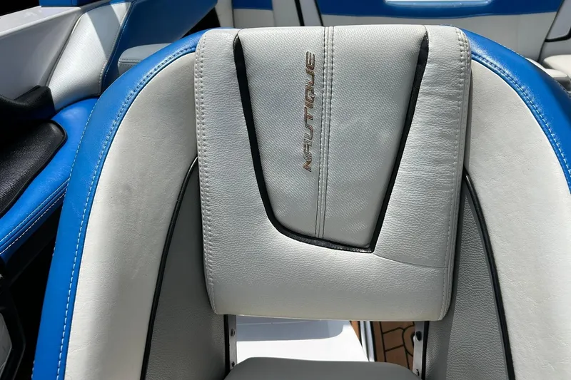 Slide: The Image of 2013 Nautique Super Air Nautique G23 boat seat with blue and white upholstery. - 40