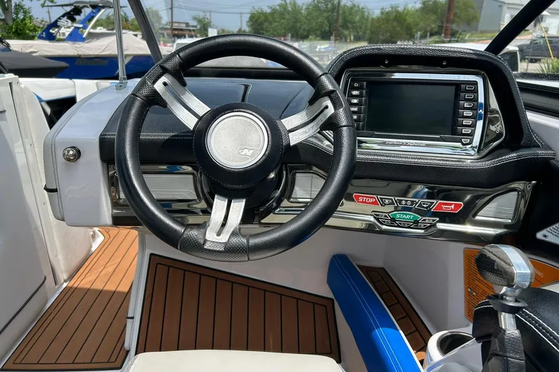 Slide: The Image of 2013 Nautique Super Air Nautique G23 dashboard with steering wheel and control panel. - 41