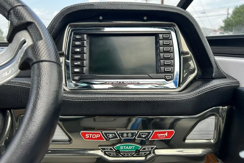 Slide: The Image of Dashboard of a 2013 Nautique Super Air Nautique G23 boat with control panel. - 42
