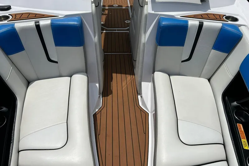 Slide: The Image of 2013 Nautique Super Air Nautique G23 interior with white and blue seating, teak flooring. - 44