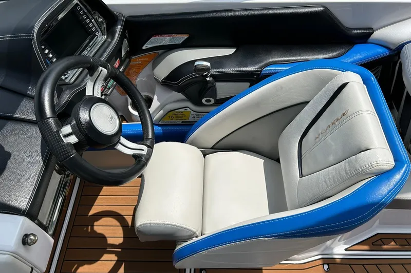 Slide: The Image of Interior of 2013 Nautique Super Air Nautique G23 boat with steering wheel and seat. - 5