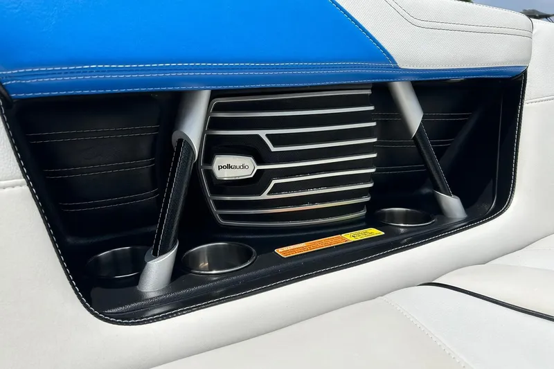 Slide: The Image of 2013 Nautique Super Air Nautique G23 interior with Polk Audio speaker and cup holders. - 50