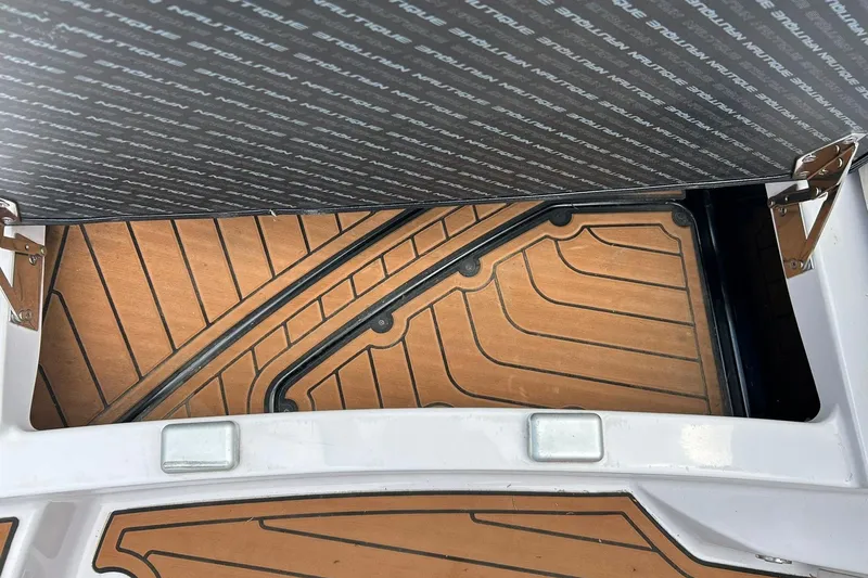 Slide: The Image of 2013 Nautique Super Air Nautique G23 boat interior with teak flooring and storage compartment. - 51
