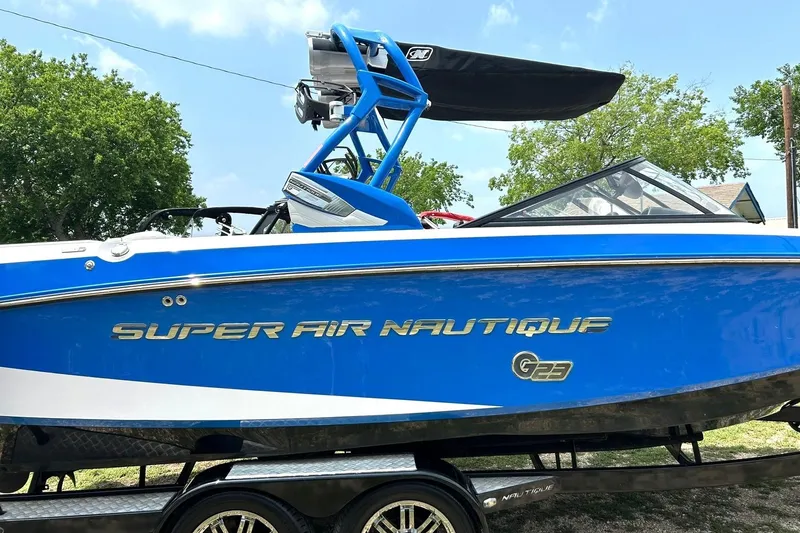 Slide: The Image of 2013 Nautique Super Air Nautique G23 boat in vibrant blue on trailer. - 7