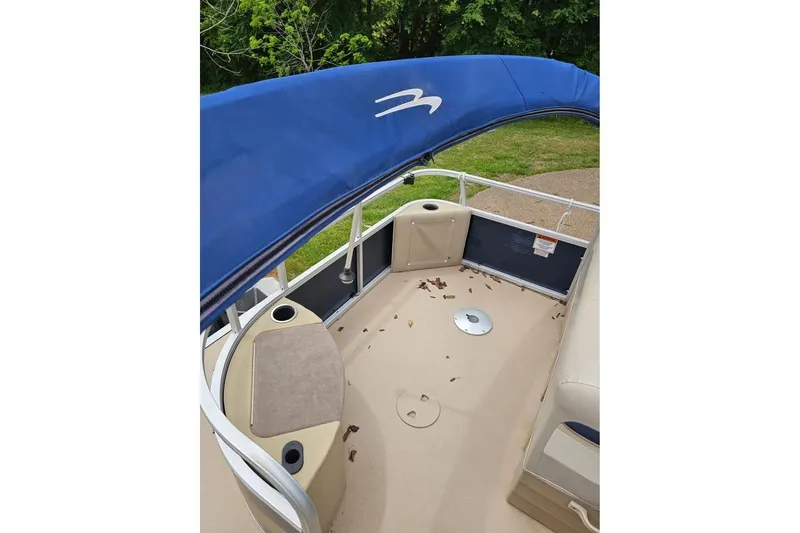 Slide: The Image of 2012 Sweetwater 20sf pontoon boat interior with blue canopy and seating. - 5