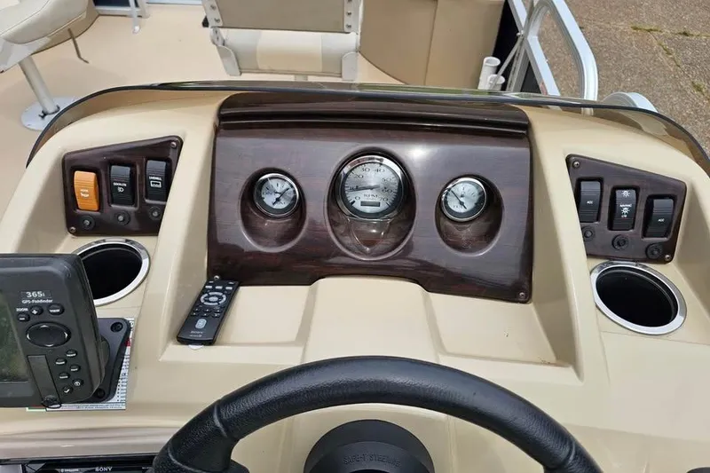 Slide: The Image of Dashboard of a 2012 Sweetwater 20sf boat with gauges and controls. - 7