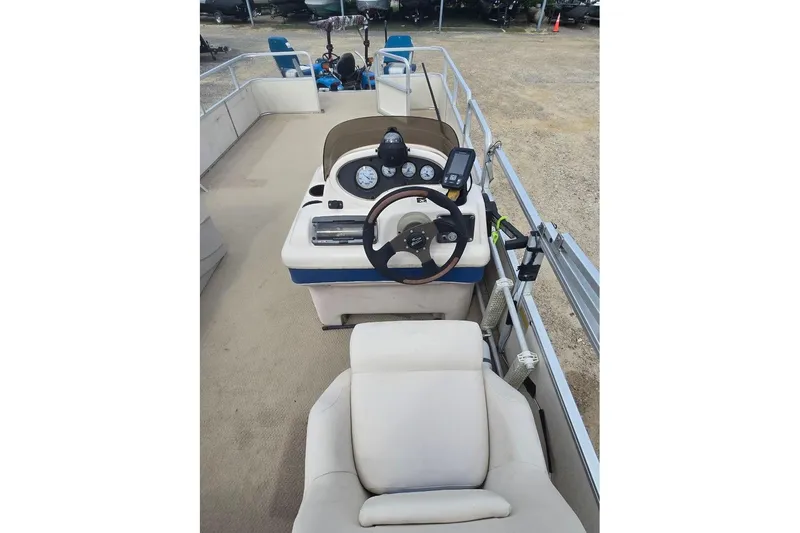 Slide: The Image of 2003 Sun Tracker Party Barge 24 interior with steering console and seating. - 4