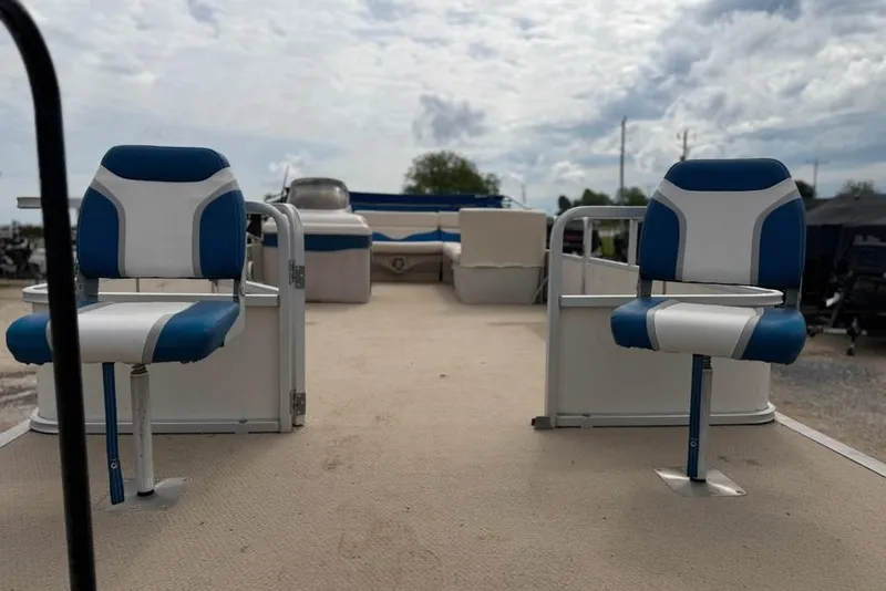 Slide: The Image of 2003 Sun Tracker Party Barge 24 pontoon boat with blue and white seating. - 7