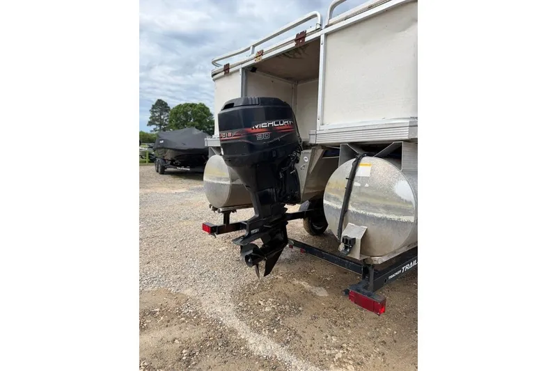 Slide: The Image of 2003 Sun Tracker Party Barge 24 with Mercury outboard motor in a parking area. - 8