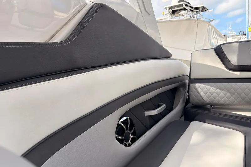 Slide: The Image of 2021 Yamaha Boats 275SD interior with luxurious seating and sleek design details. - 16
