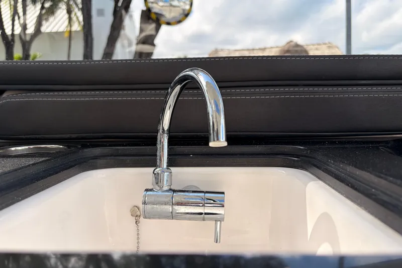 Slide: The Image of Chrome faucet on 2021 Yamaha Boats 275SD, set against a sleek black and white interior. - 17