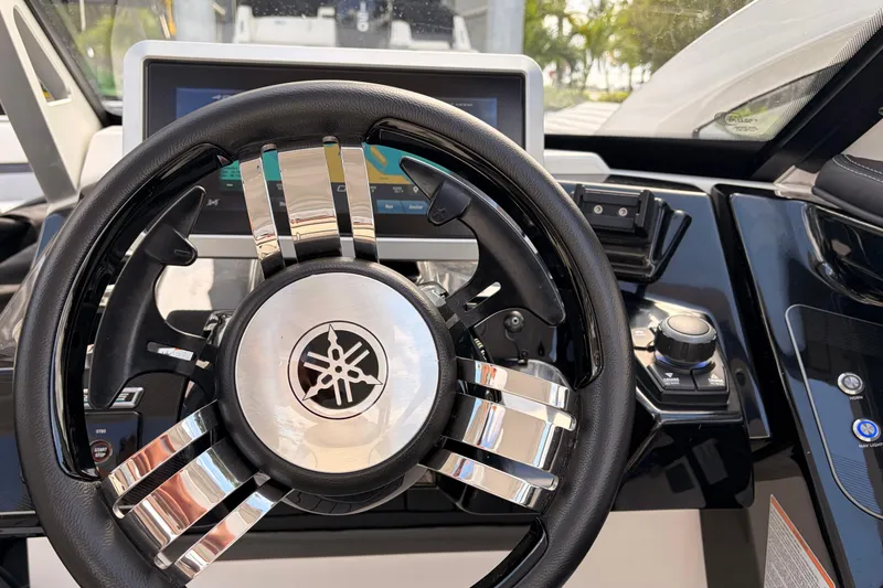Slide: The Image of Steering wheel of 2021 Yamaha Boats 275SD with dashboard controls. - 19