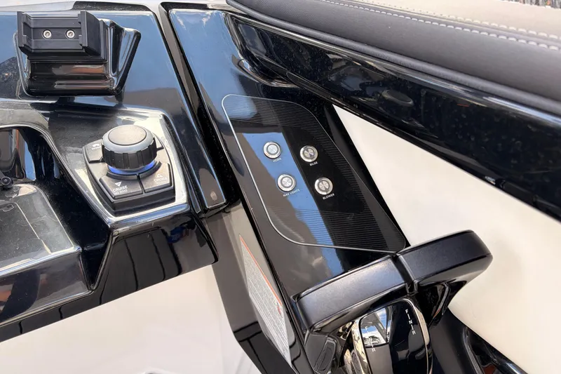 Slide: The Image of Control panel of 2021 Yamaha Boats 275SD, featuring sleek black design and modern controls. - 23