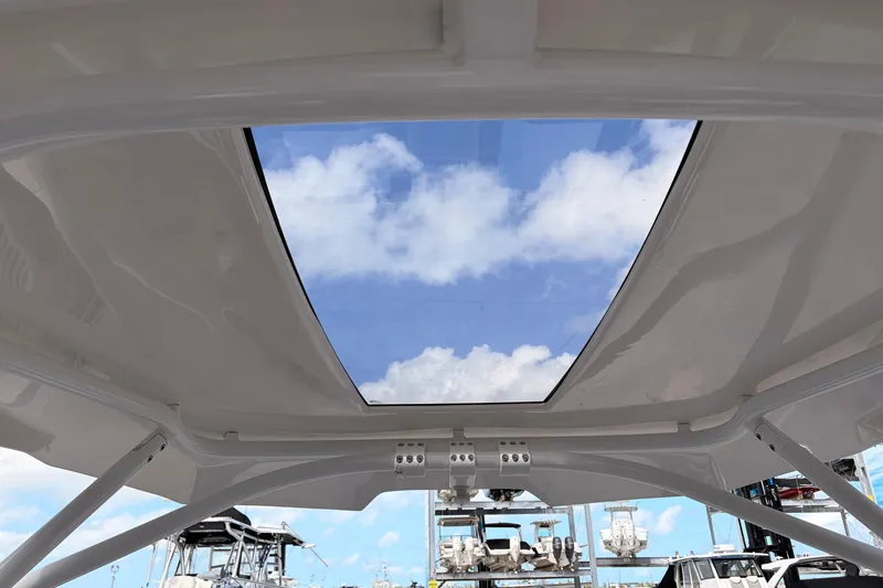 Slide: The Image of 2021 Yamaha Boats 275SD with open sunroof, showcasing blue sky and clouds. - 26
