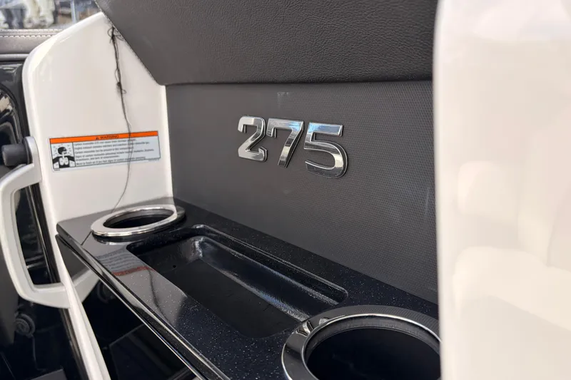 Slide: The Image of 2021 Yamaha Boats 275SD interior detail with cup holders and model emblem. - 31