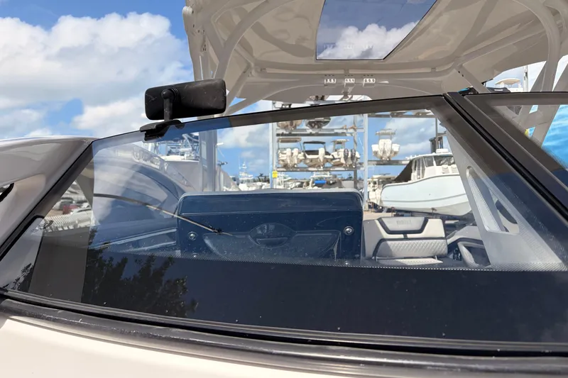 Slide: The Image of 2021 Yamaha Boats 275SD windshield view with marina background. - 36