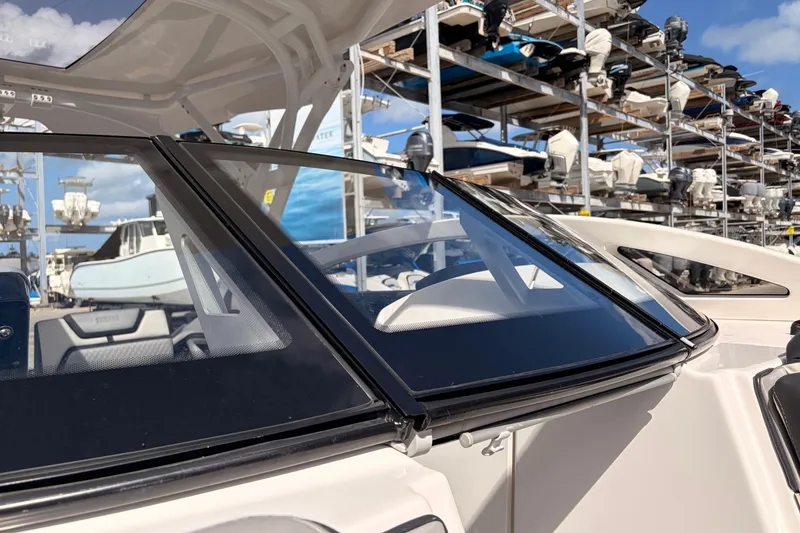 Slide: The Image of 2021 Yamaha Boats 275SD windshield with marina backdrop and stacked boats. - 37