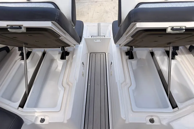 Slide: The Image of 2021 Yamaha Boats 275SD interior storage compartments with open seats. - 39