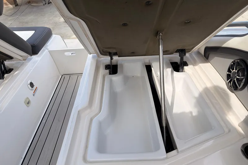 Slide: The Image of 2021 Yamaha Boats 275SD storage compartment with open lid and speaker detail. - 42