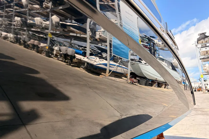Slide: The Image of 2021 Yamaha Boats 275SD reflecting in marina storage, showcasing sleek design and polished finish. - 47