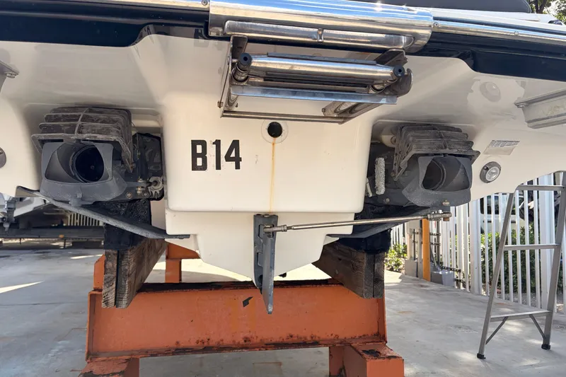 Slide: The Image of Rear view of a 2021 Yamaha Boats 275SD on a stand, showcasing dual jet nozzles. - 53