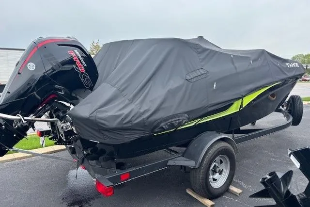 Slide: The Image of 2024 Tahoe T18 boat covered on trailer, featuring a powerful outboard motor. - 3