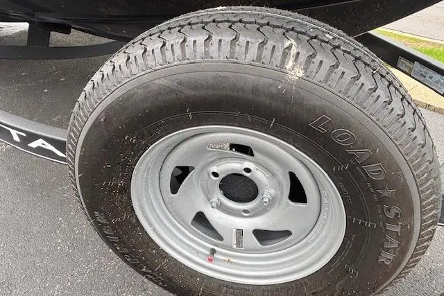 Slide: The Image of 2024 Tahoe T18 trailer tire, Load Star brand, on asphalt surface. - 31