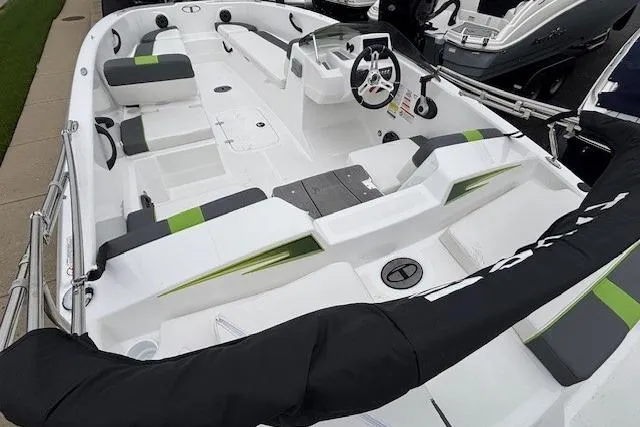 Slide: The Image of 2024 Tahoe T18 boat interior with modern seating and steering wheel, featuring green accents. - 33